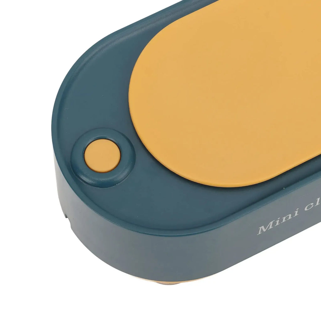 Close-up of a blue and yellow electronic device with 'Mini Click' branding.