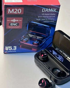 Wireless earbuds with charging case and DAMIX M20 packaging on a light surface.