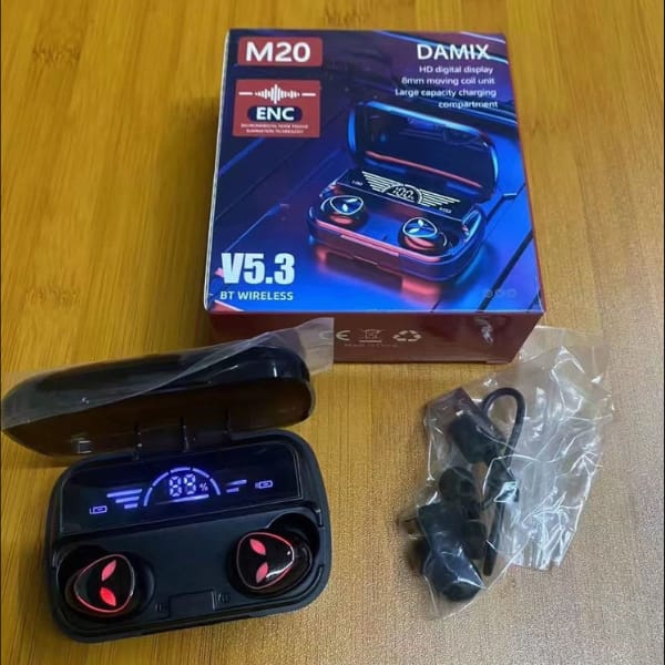 Wireless earbuds with charging case and packaging on a wooden surface