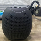 Black VEZO Bluetooth speaker with front grille and carrying loop