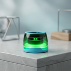 Small green and blue device on a light gray surface with a blurred background