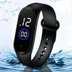 Black smartwatch with digital display on a water-themed background