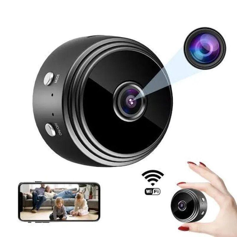 Small black camera with smartphone app interface and hand holding the camera.