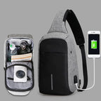 Gray crossbody bag with smartphone charging feature on a gray background