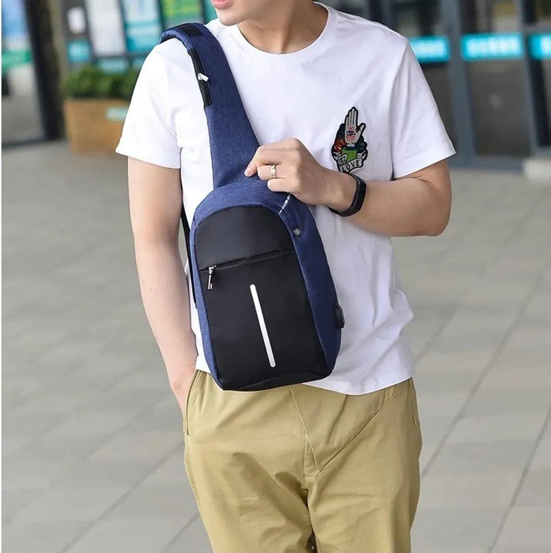 Person wearing a blue and black crossbody bag on a blurred background